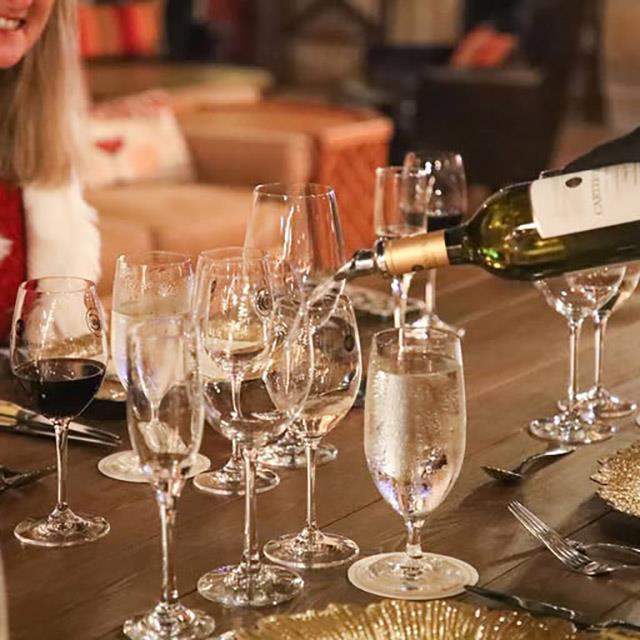 wine being poured into multiple glasses